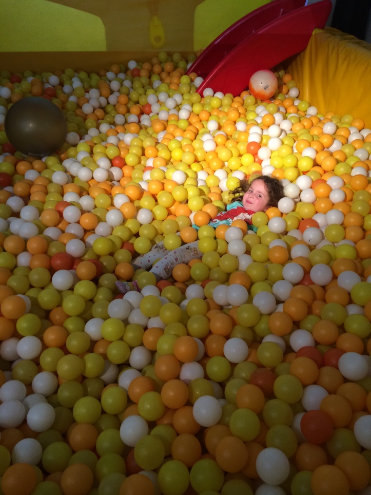 Little girl in a ball pit